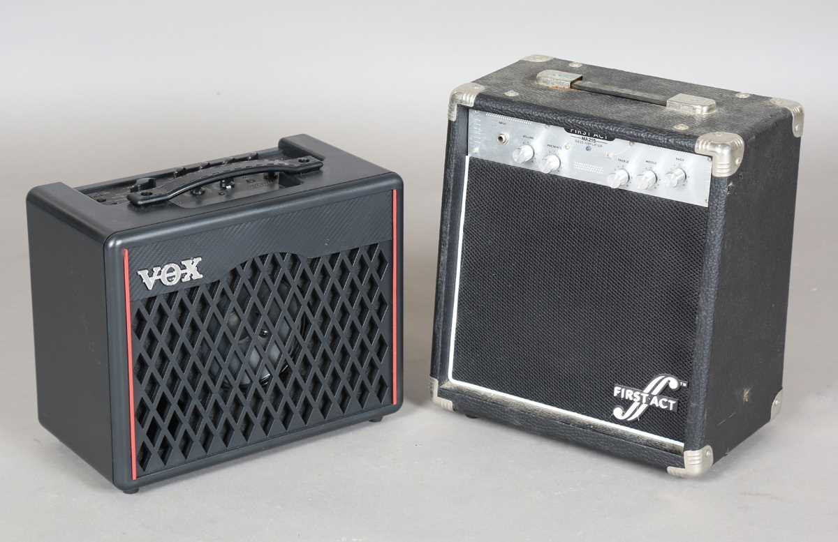 A First Act MA215 bass amplifier, width 33cm, and a Vox VX-1 modelling guitar amplifier.