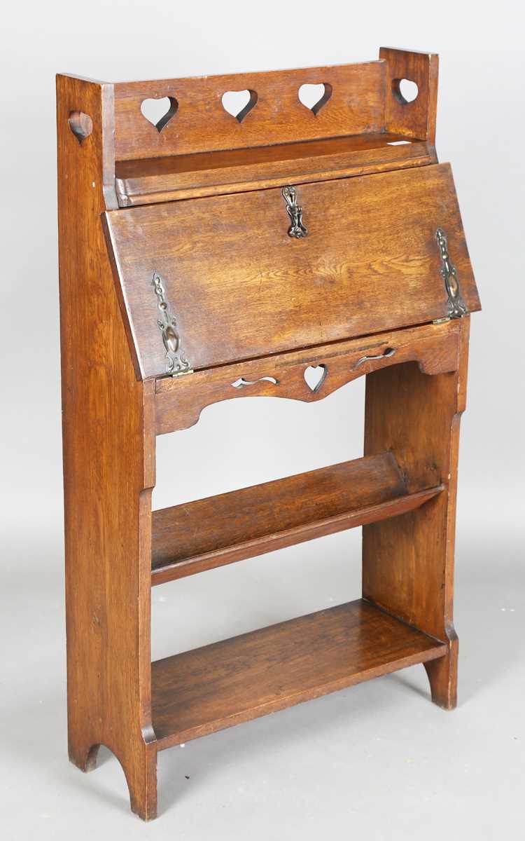 An early 20th century Arts and Crafts oak student's bureau, in the manner of Liberty & Co, height