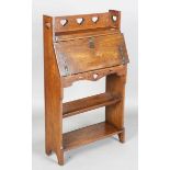 An early 20th century Arts and Crafts oak student's bureau, in the manner of Liberty & Co, height