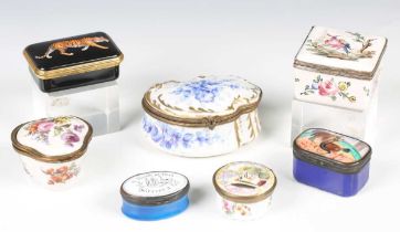 A group of seven mainly 19th century porcelain and enamel snuff and patch boxes, including a Bilston