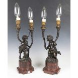 A pair of mid/late 19th century French dark brown patinated cast bronze twin-light candelabra, after