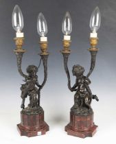 A pair of mid/late 19th century French dark brown patinated cast bronze twin-light candelabra, after