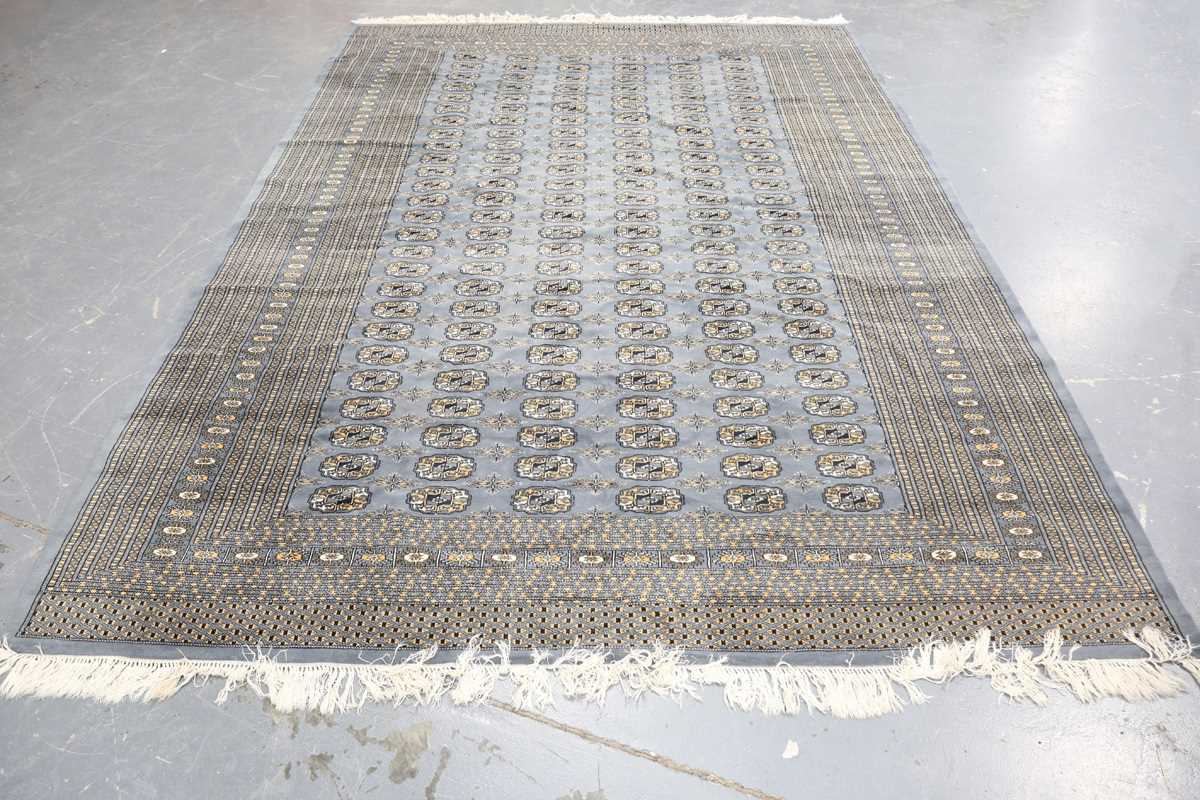 A Pakistan bokhara style carpet, late 20th century, the grey field with overall columns of guls,