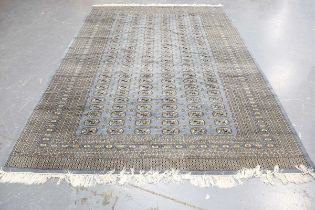 A Pakistan bokhara style carpet, late 20th century, the grey field with overall columns of guls,