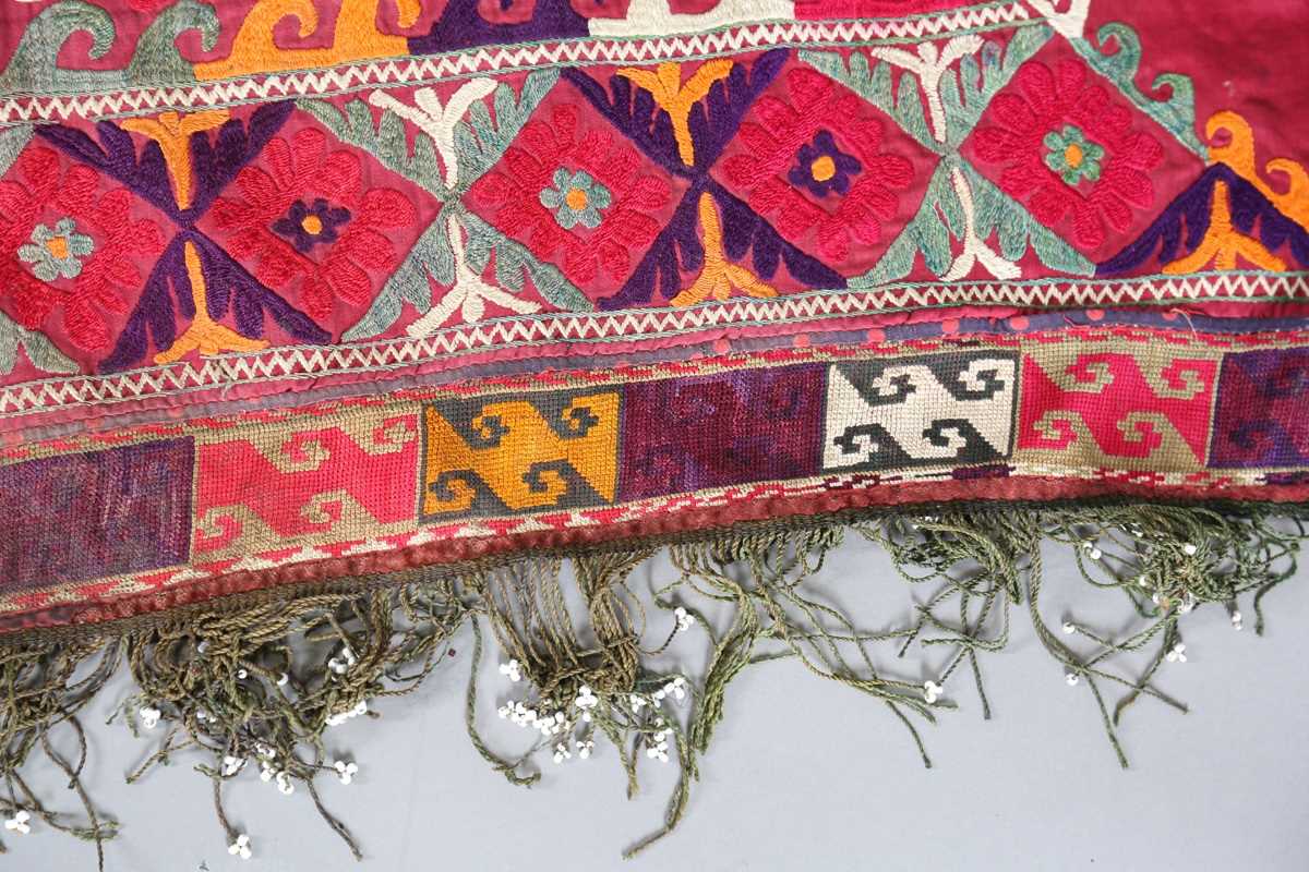 An Uzbekistan silk embroidered suzani, the triangular panel finely worked with scrolling - Image 4 of 12