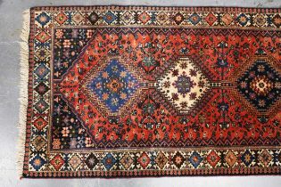 A Yalameh runner, North-west Persia, late 20th century, the red field with a column of six linked
