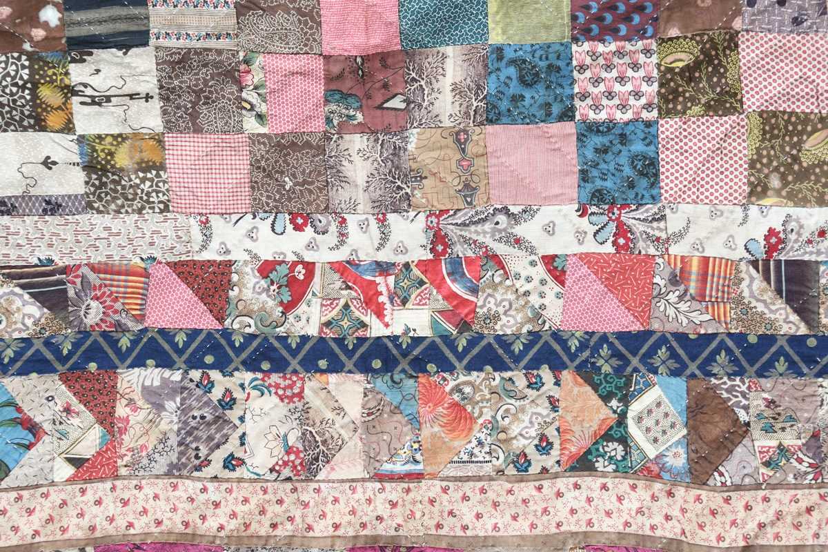 A large mid-19th century cotton 'medallion' patchwork quilt, finely worked with overall printed - Image 3 of 10