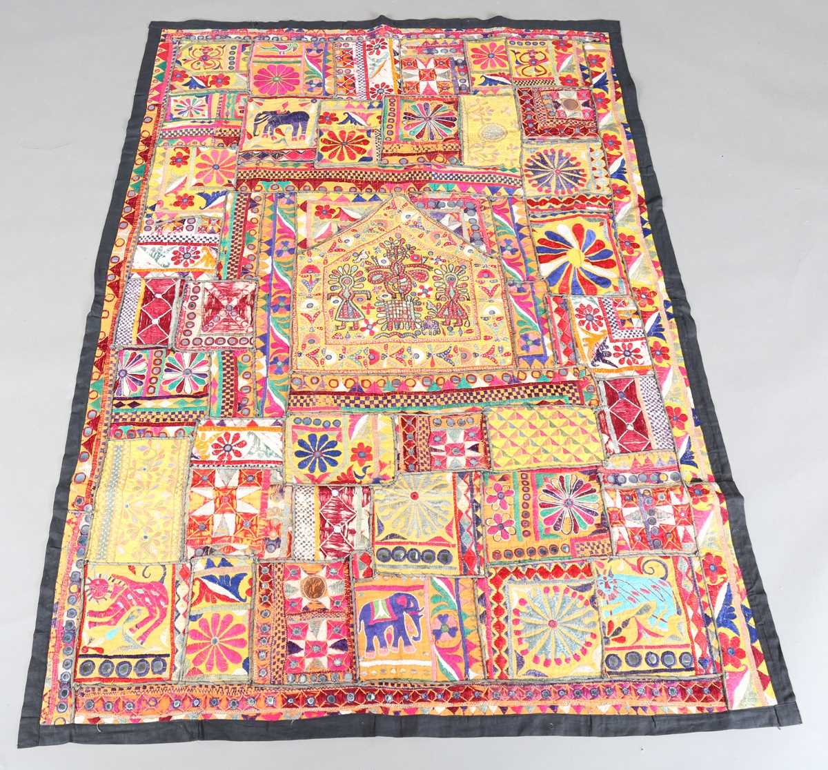 An Indian kutch mirrorwork panel, the central figural panel within a compartmentalized surround,