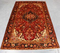 A Hamadan rug, North-west Persia, late 20th century, the claret field with a flowerhead medallion,