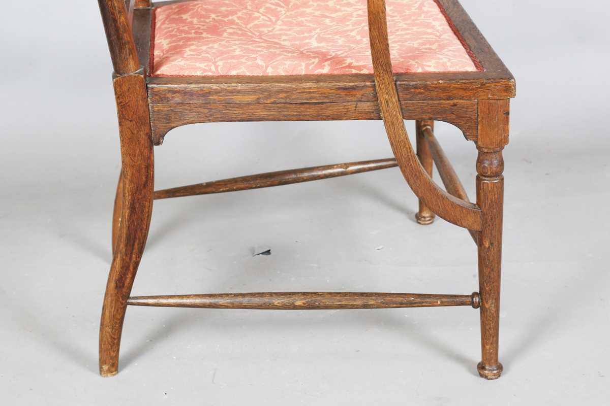 An Edwardian Arts and Crafts oak framed elbow chair, attributed to J.S. Henry, with later fitted - Image 8 of 11