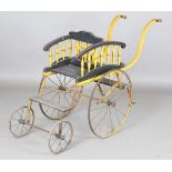 A Victorian yellow and black painted coach-built double-seated push-along infant's carriage, on a