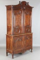 A 19th century French oak side cabinet with an arched pediment and four carved panel doors, height