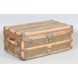 An early 20th century Louis Vuitton travelling trunk with overall monogram canvas covering and tan