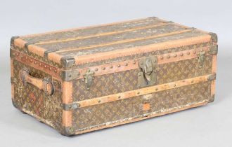 An early 20th century Louis Vuitton travelling trunk with overall monogram canvas covering and tan