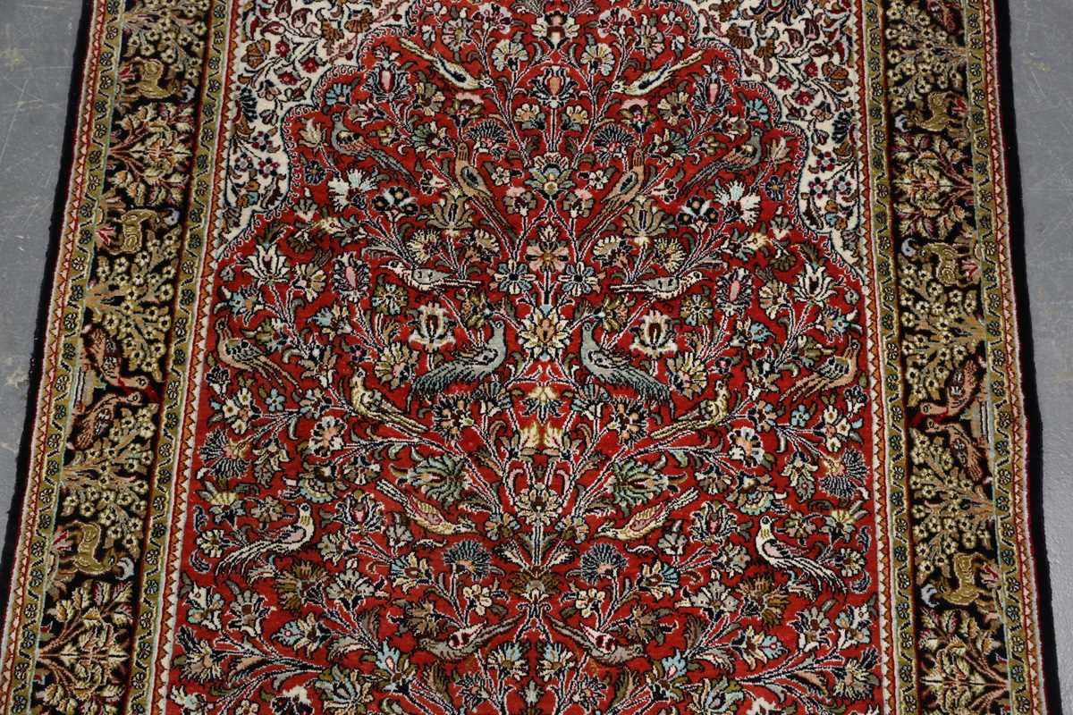 A Qum part silk prayer rug, Central Persia, late 20th century, the red mihrab with an ascending vase - Image 3 of 6