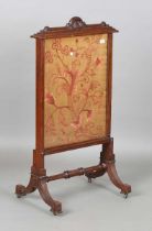 A late Victorian walnut framed firescreen, inset with a pink floral silkwork panel, height 112cm,