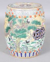 A mid-20th century Chinese porcelain jardinière stand of barrel form, enamelled with landscape