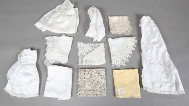 A mixed group of whitework, including infants' linen gowns, a baby's cape with lacework edging and
