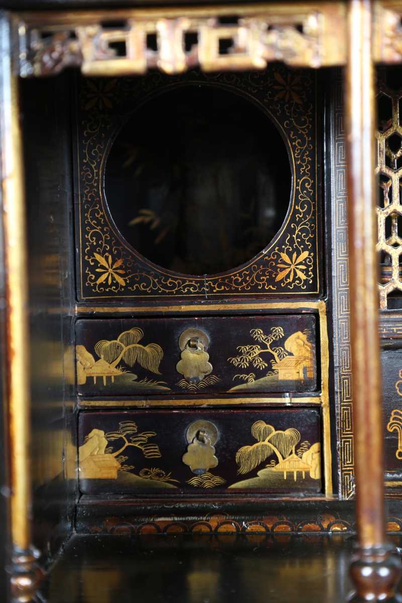 An 18th century Chinese black lacquered collector's cabinet, decorated in gilt with landscape - Image 6 of 28