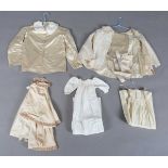 A mixed group of late 19th and early 20th century infants' clothing and dolls' clothing, including a