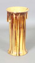 A 19th century French yellow tin glazed stick stand, the cylindrical body with angular handles,