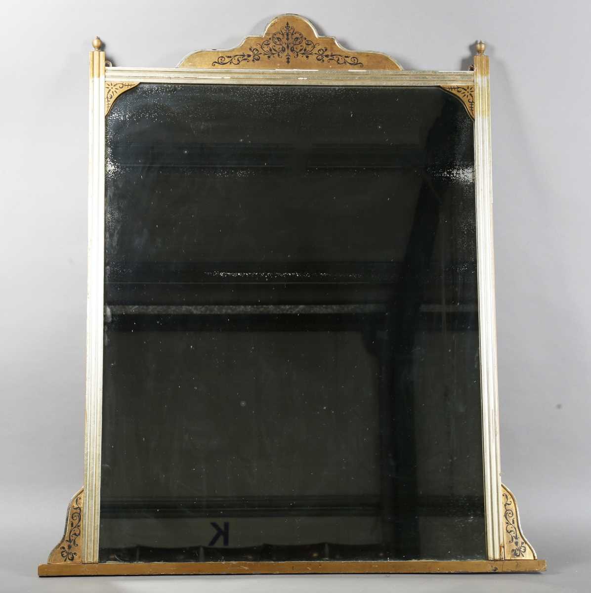 A late Victorian giltwood overmantel mirror with black painted foliate decoration, 140cmm x 121cm.