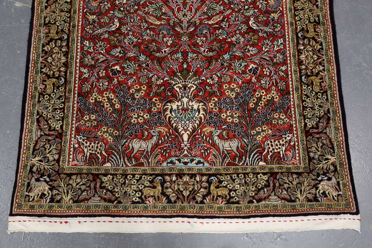A Qum part silk prayer rug, Central Persia, late 20th century, the red mihrab with an ascending vase - Image 4 of 6