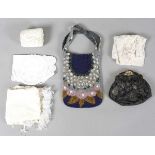 A mixed group of textiles, lace bobbins, buckles and two evening bags, including a roll of red