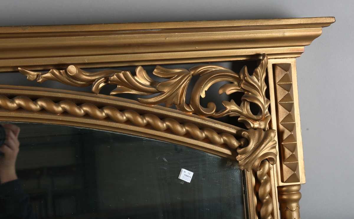 A late Victorian gilt painted overmantel mirror with pierced foliate corner panels and spiral turned - Image 2 of 9