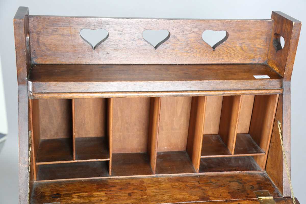 An early 20th century Arts and Crafts oak student's bureau, in the manner of Liberty & Co, height - Image 4 of 11
