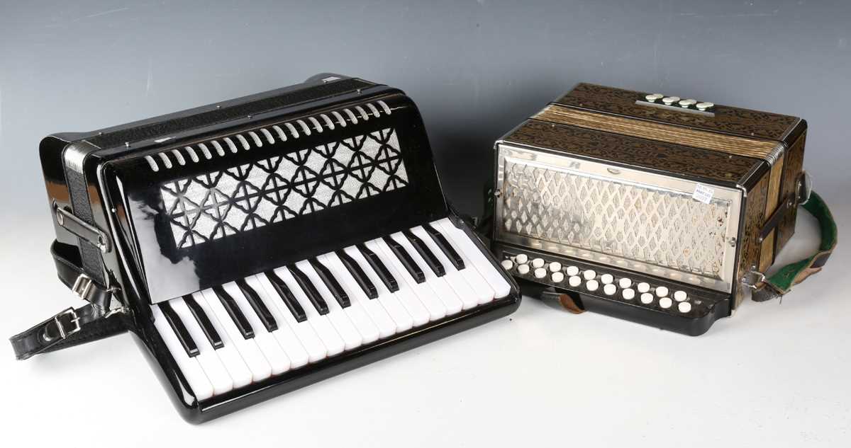 A Hohner accordion and a modern black cased piano accordion.