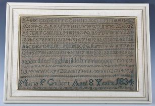 A William IV needlework sampler by Maria P Gilbert, aged 8 years, dated 1834, finely worked in green