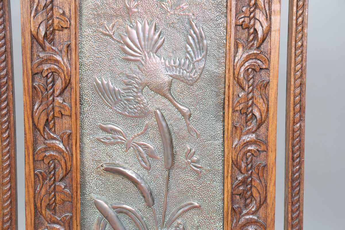 A late Victorian Arts and Crafts oak framed and copper inset firescreen, the panel worked with - Image 4 of 7