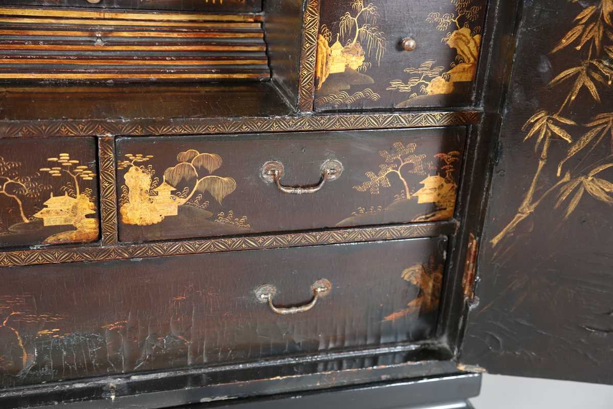 An 18th century Chinese black lacquered collector's cabinet, decorated in gilt with landscape - Image 5 of 28