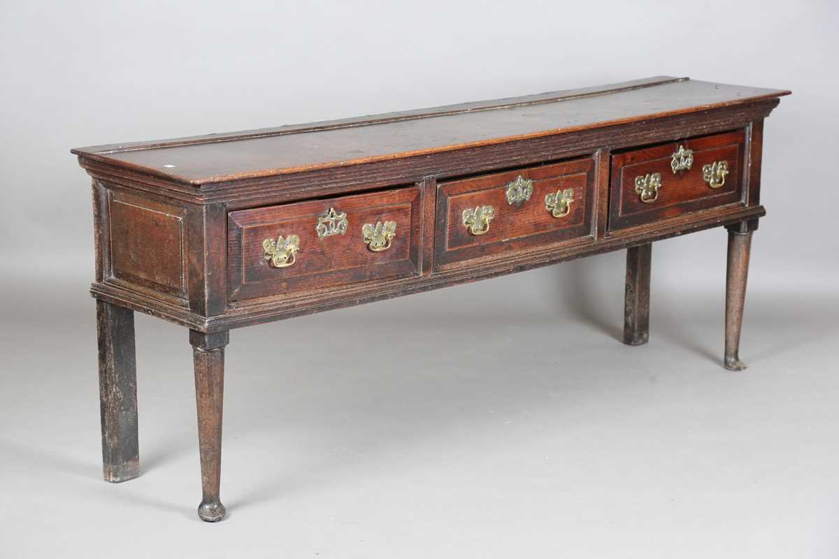 An early 18th century provincial oak dresser base, fitted with three deep drawers, height 77cm,