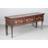 An early 18th century provincial oak dresser base, fitted with three deep drawers, height 77cm,
