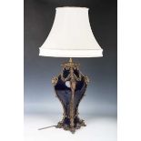 A modern blue glazed porcelain and brass mounted table lamp with ram's head and foliate mounts,