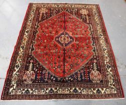 An Abadeh rug, South-west Persia, late 20th century, the red field with a column medallion, within
