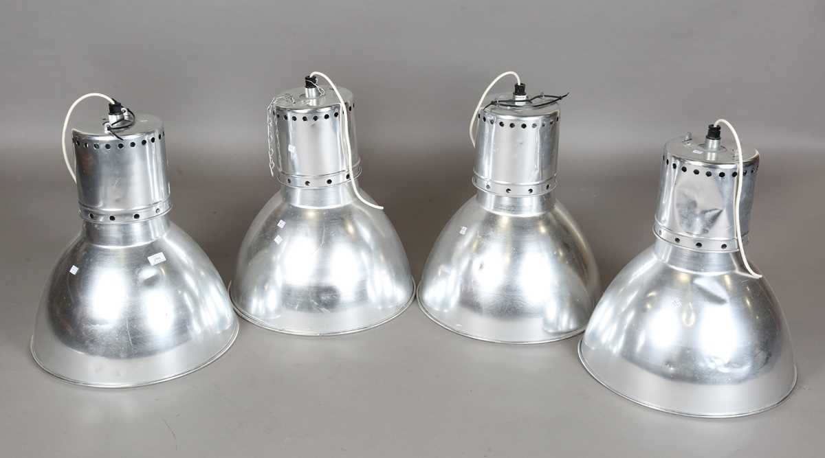 A set of four aluminium industrial ceiling lights of domed form, height 55cm, diameter 50cm.