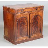 An early Victorian mahogany wash cabinet, fitted with a hinged lid above two arch panelled doors,