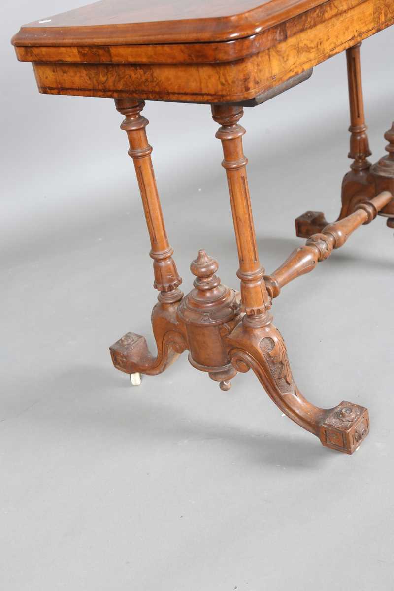 A mid-Victorian burr walnut rectangular fold-over card table, raised on fluted legs and carved feet, - Image 9 of 14