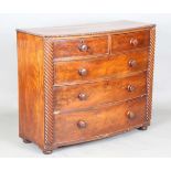 An early Victorian mahogany bowfront chest of drawers with reeded pilasters and squat bun feet,