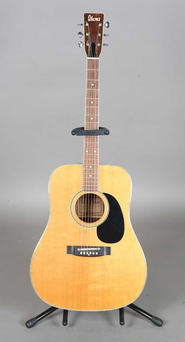 A 1970s Ibanez Concord 696 six-string dreadnought acoustic guitar, with gig bag and stand.