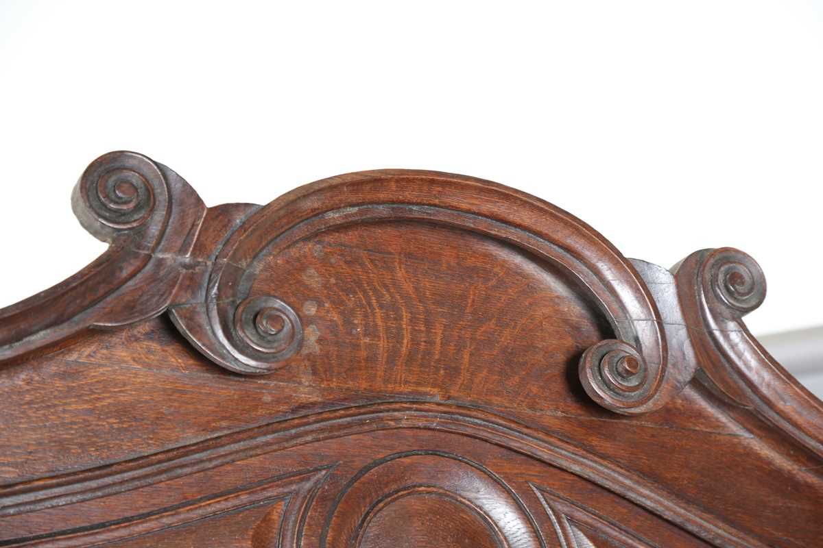 A 19th century French oak side cabinet with an arched pediment and four carved panel doors, height - Image 2 of 14