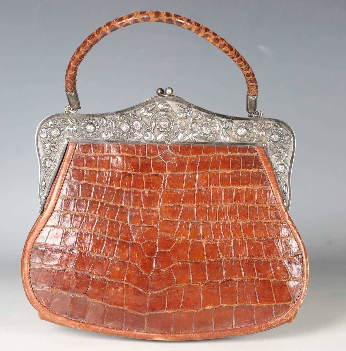 An early 20th century crocodile skin handbag, the white metal clasp decorated with lotus flowers and - Image 13 of 13