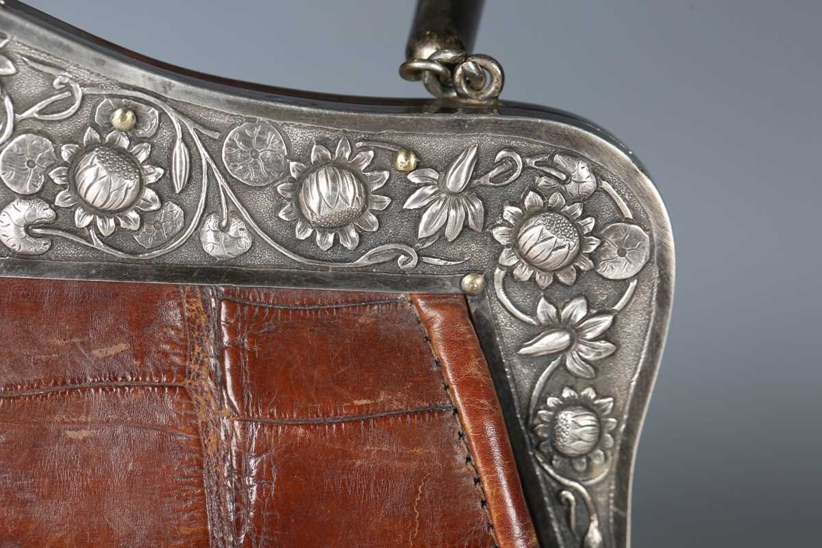 An early 20th century crocodile skin handbag, the white metal clasp decorated with lotus flowers and - Image 3 of 13