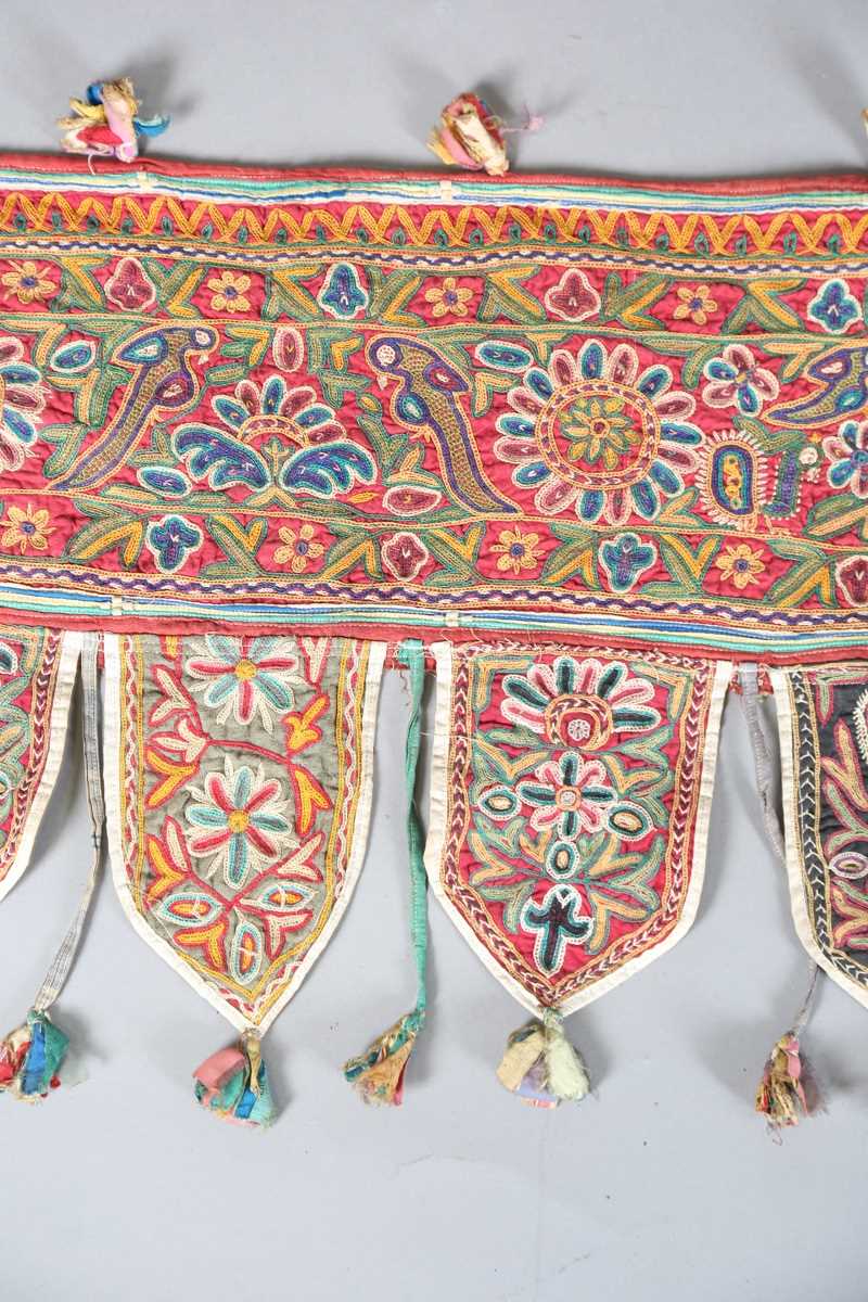 An Indian kutch embroidered door hanging, finely worked in coloured threads, width 98cm. Provenance: - Image 4 of 6