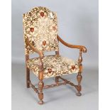 An early 20th century Carolean Revival beech framed armchair, upholstered in heraldic cut velour,