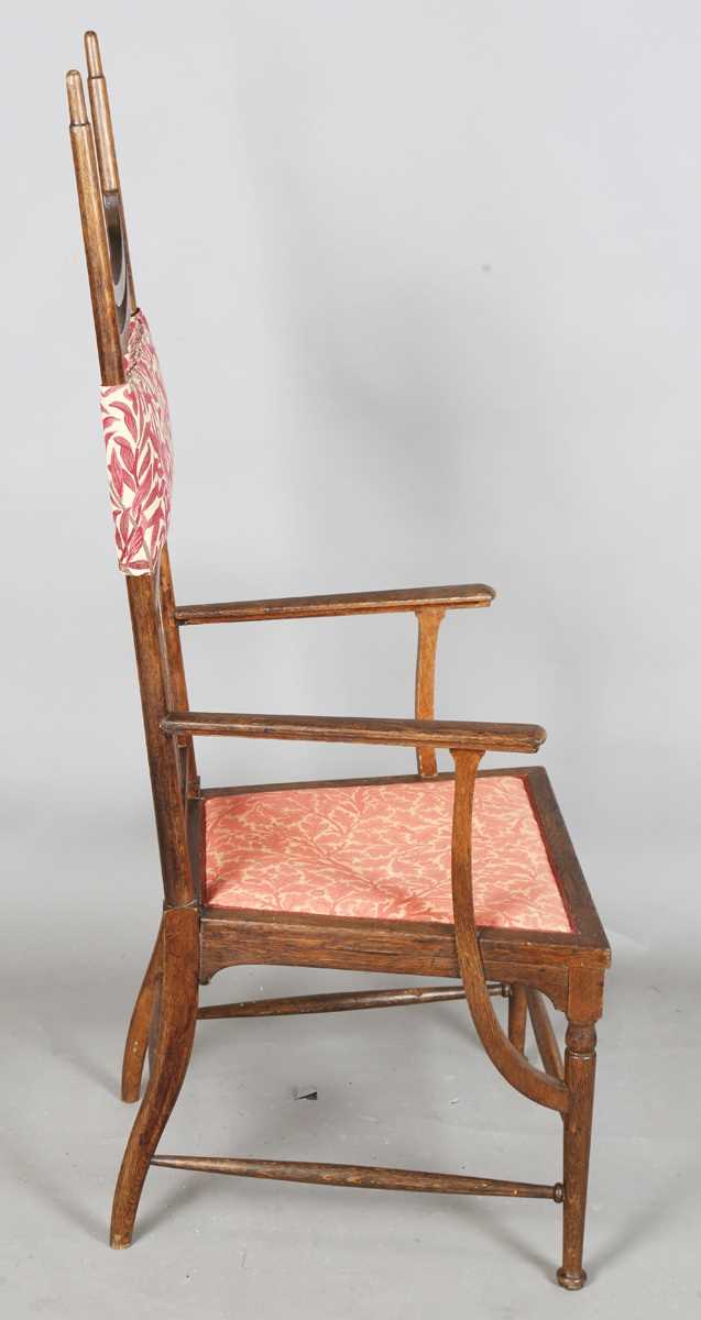 An Edwardian Arts and Crafts oak framed elbow chair, attributed to J.S. Henry, with later fitted - Image 7 of 11
