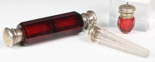 A late 19th century cut clear glass scent bottle of conical form with screw-off white metal lid,